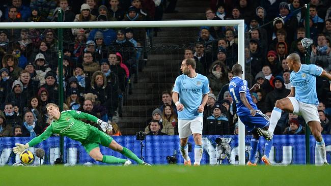 Manchester City's English goalkeeper Joe Hart is beaten by Ivanovic. 