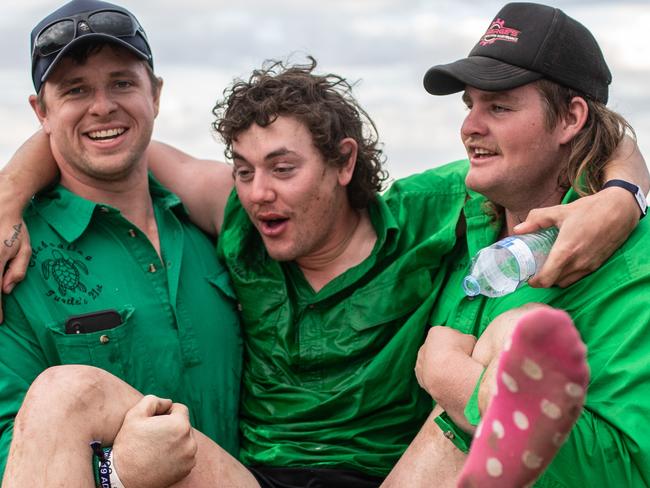 DENILIQUIN, AUSTRALIA - OCTOBER 04: Festival goers carry a drunken friend back to their camp at the 2019 Deni Ute Muster on October 04, 2019 in Deniliquin, Australia. The annual Deniliquin Ute Muster is the largest ute muster in Australia,  attracting more than 18,000 people to the rural town of Deniliquin together to celebrate all things Australian and the icon of the Ute in a weekend of music, competitions and camping. (Photo by James Gourley/Getty Images)