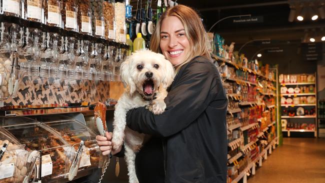 Lisa Clark with her dog at Coles' new dog treats pick and mix bar. Picture: Richard Dobson.