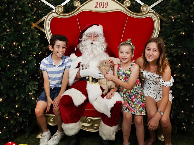 Santa with James Petrovski, his sisters Chloe and Sasha and their pet rabbit April. Picture: Rohan Kelly