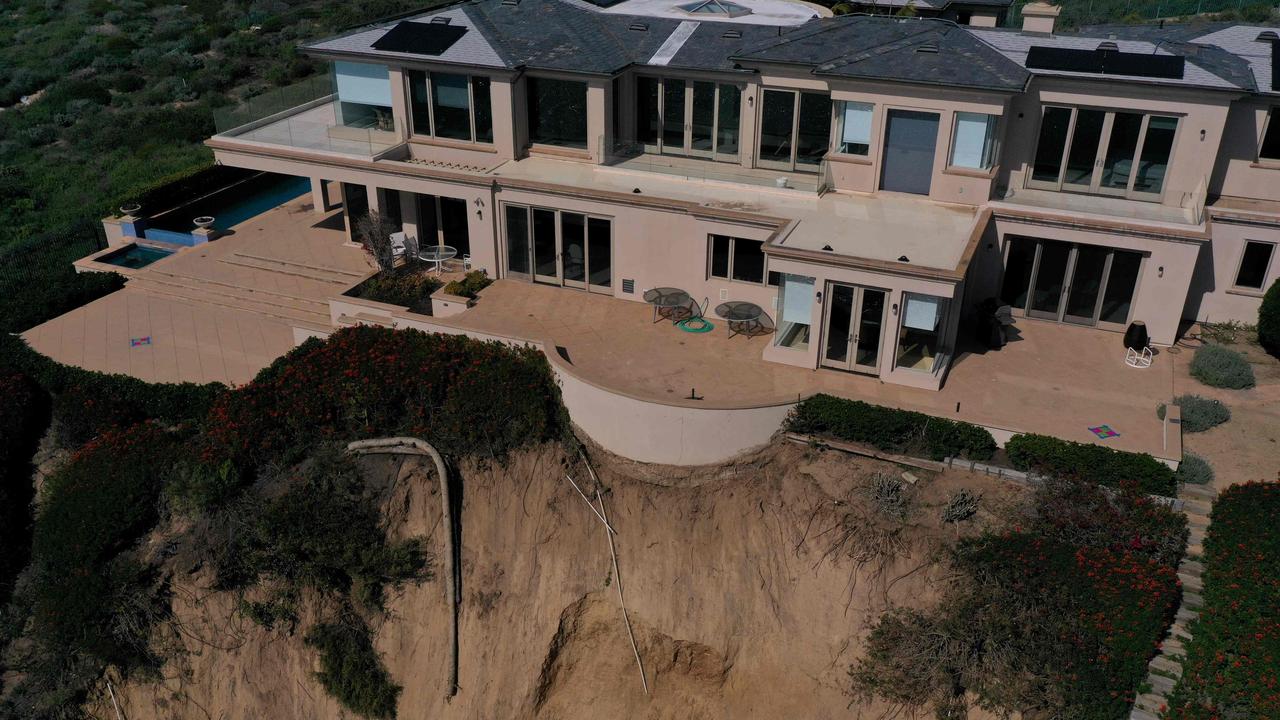 This aerial photograph shows homes along Scenic Drive standing on the edge of a cliff above the Pacific Ocean after a landslide following heavy rains in Dana Point, California, on February 15, 2024. Picture:: Patrick T. Fallon / AFP