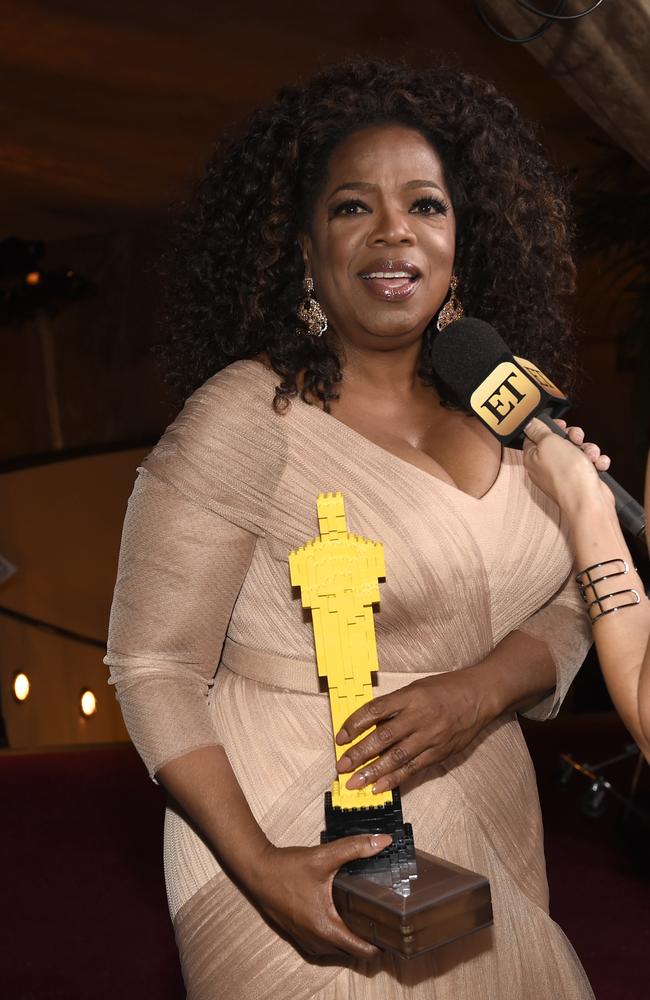 Oprah Winfrey poses with a Lego Oscar statuette at the Governors Ball.