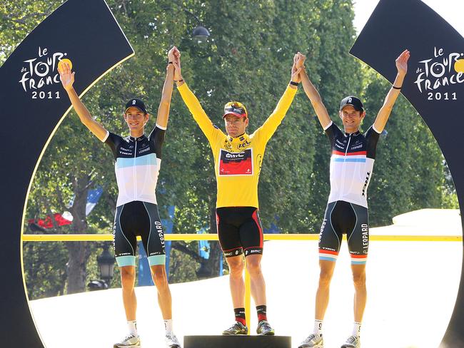 Cadel Evans on top of the 2011 Tour de France podium with Andy and Frank Schleck.