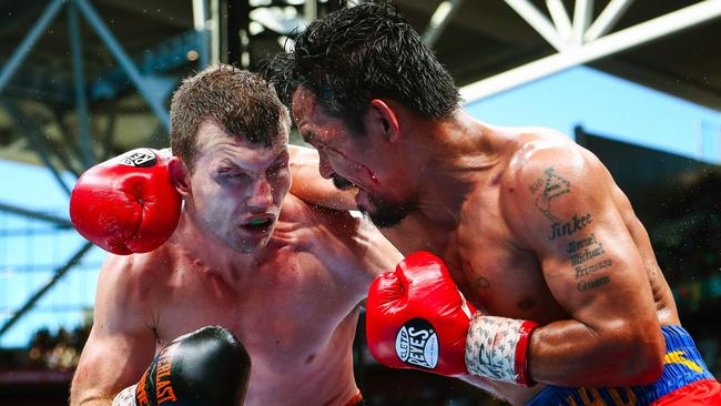Jeff Horn (L) and Manny Pacquiao slug it out at Suncorp Stadium.