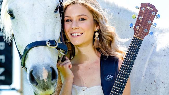 HOLD SATURDAY COURIER MAIL 7TH SEP  Caitlyn Shadbolt poses for a photograph with 'Ghost' at Doomben Racecourse to promote Country Music Raceday, Monday, September 2, 2019 (AAP Image/Richard Walker)