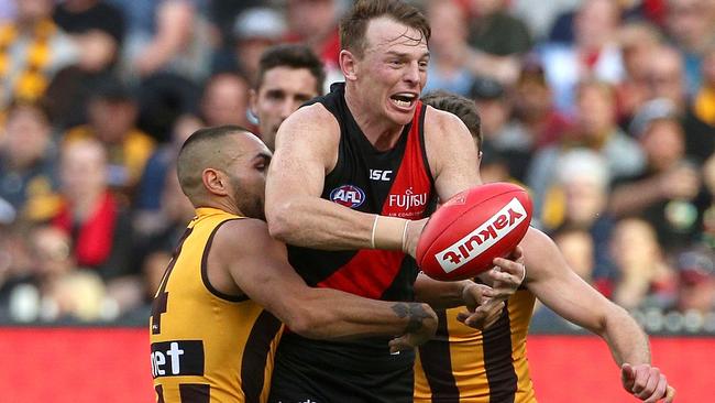 Brendon Goddard is tackled by two Hawthorn players during the loss last Saturday.