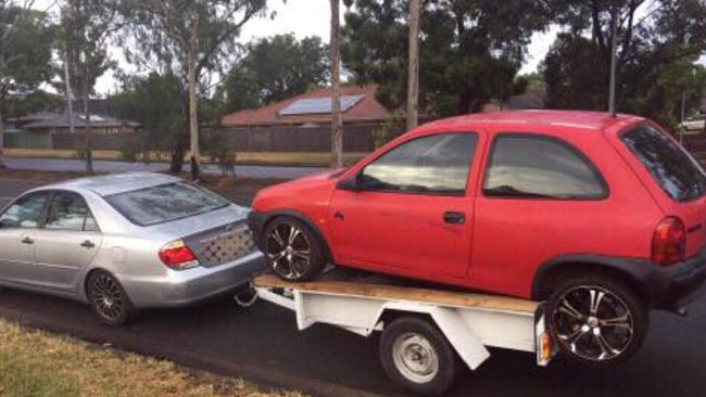 The man tries to tow a small car on a box trailer through Mt Druitt. Picture: Traffic and Highway Patrol Command
