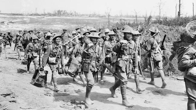 Australian machine gunners returning from the front line trenches, walking along a road near Pozieres. Picture: Australian War Memorial