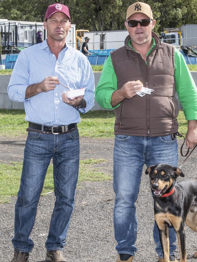 Craig Freestone and Adam Miller with Tim the kelpie take a break from the sheepdog trials. Toowoomba Royal Show. Friday, March 31, 2023. Picture: Nev Madsen.