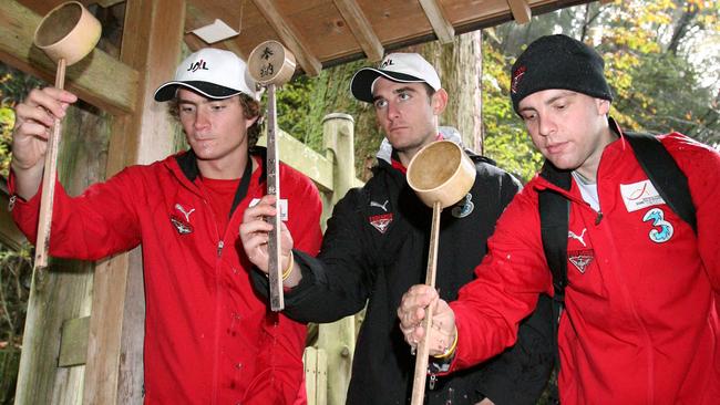 Bombers Ricky Dyson, Jobe Watson and Adam Ramanauskas purify themselves at Mount Hiei in Otsu, Shiga, Japan.