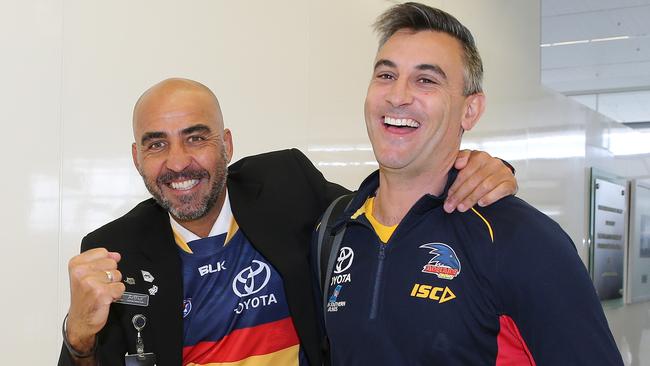 Scott Camporeale gets cheered on by Virgin Lounge supervisor Arthur Floros at Adelaide Airport. Picture: Dylan Coker