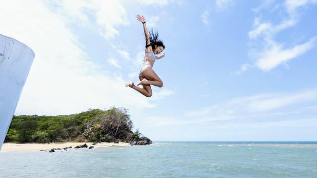 The hot, sticky weather Cairns is experiencing is forecast to continue for a while yet. Milo Sanchez, 14, cools off from the heat by jumping into the ocean at Palm Cove. Picture: Brendan Radke