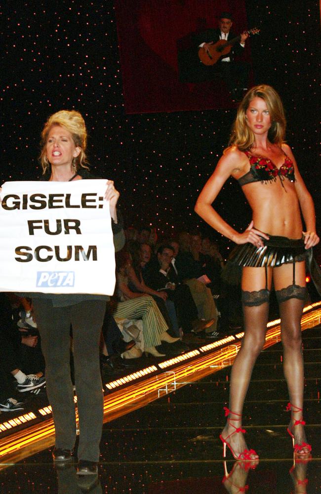 Gisele Bundchen’s walk is interrupted by anti-fur protestors at the 2002 Victoria's Secret Fashion Show. Picture: Evan Agostini, ImageDirect.