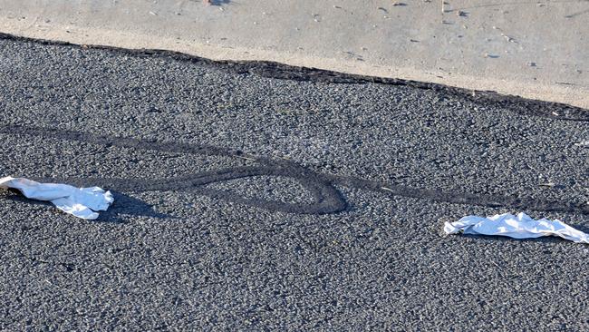 Gloves lying discarded on the ground near to the home where a woman and a child were stabbed. Picture: Steve Pohlner