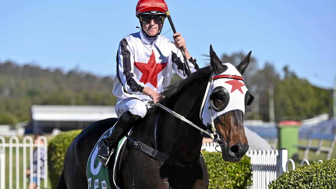 Jockey Jackson Murphy salutes with victory aboard Raging Royal at Ipswich racetrack. Picture: Cordell Richardson