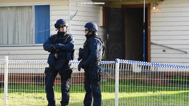 Police stand gaurd at a property in Pascoe Vale after arresting two men possibly involved in the shooting of a police officer a couple of weeks ago. Picture: Jake Nowakowski