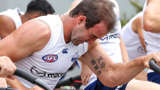 Ben Cunnington sweats in out on the training bikes at Arden St. Picture: Ian Currie