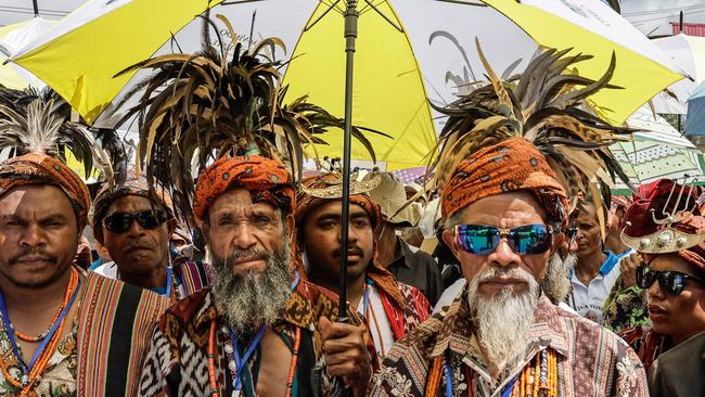 Catholic faithful wait on a street to welcome Pope Francis in Dili in 2024. Picture: AP.