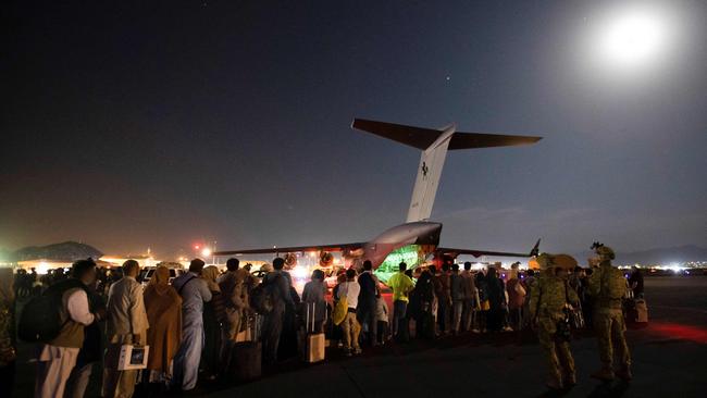 People form a line to board an RAAF flight at Hamid Karzai International Airport in Kabul. Picture: AFP/ADF