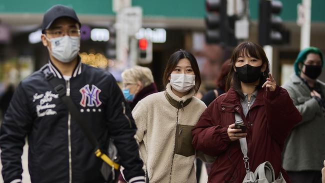 Members of the public wear face masks as they commute around the CBD. Picture Getty Images