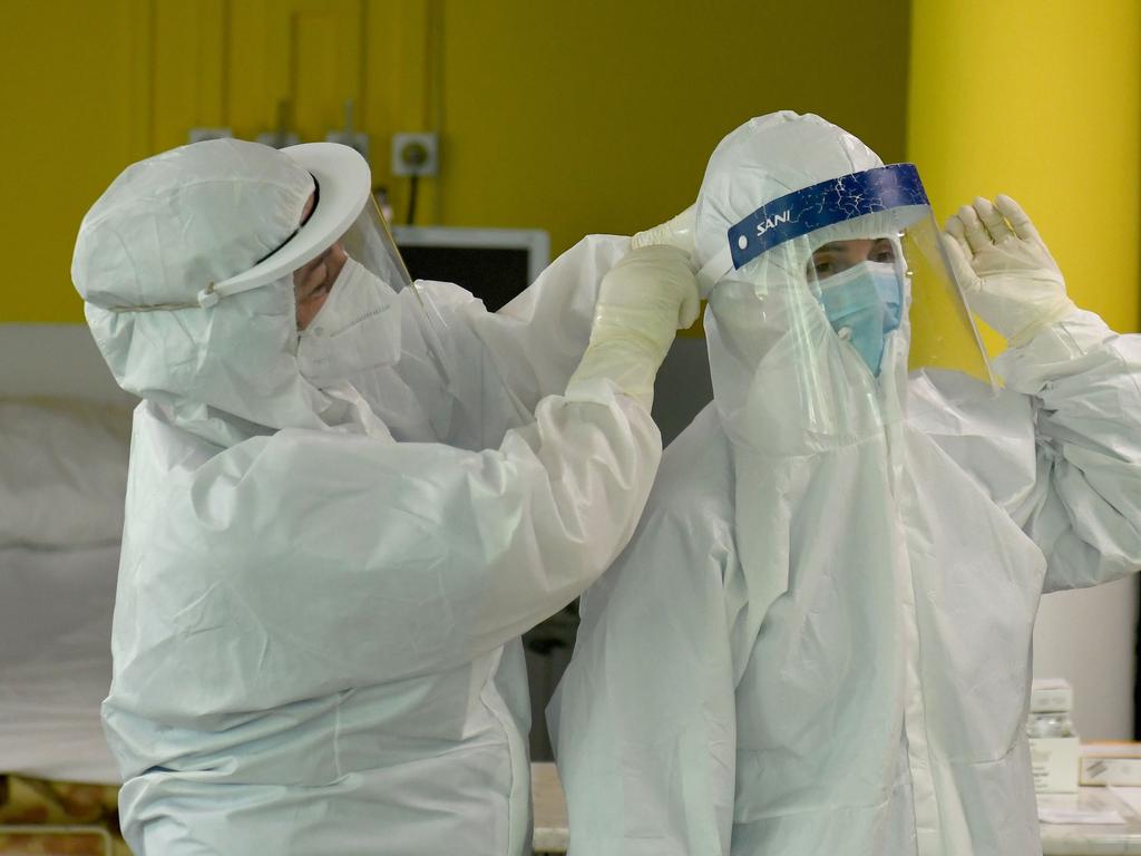 Nurses help each other to put on a protective equipment at the intensive care unit of the Shefqet Ndroqi Sanatorium hospital. Picture: Gent SHKULLAKU / AFP