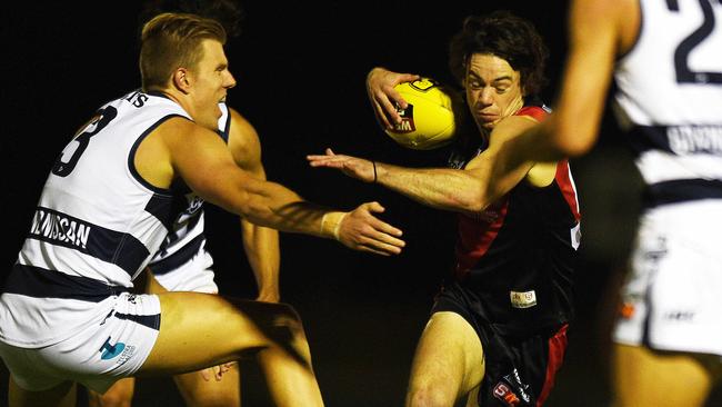 West Adelaide’s Hugh Haysman looks to escape the Panthers’ defence.