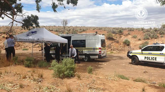 Major Crime detectives and forensic police excavate and examine a shallow grave in the Flinders Ranges, north of Hawker, where the body of a missing woman was found. Picture: SA Police