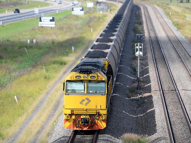 A loaded coal train is seen passing through the outskirts of Singleton, in the NSW Hunter Valley region, on Sunday, April 22, 2018. (AAP Image/Dan Himbrechts) NO ARCHIVING