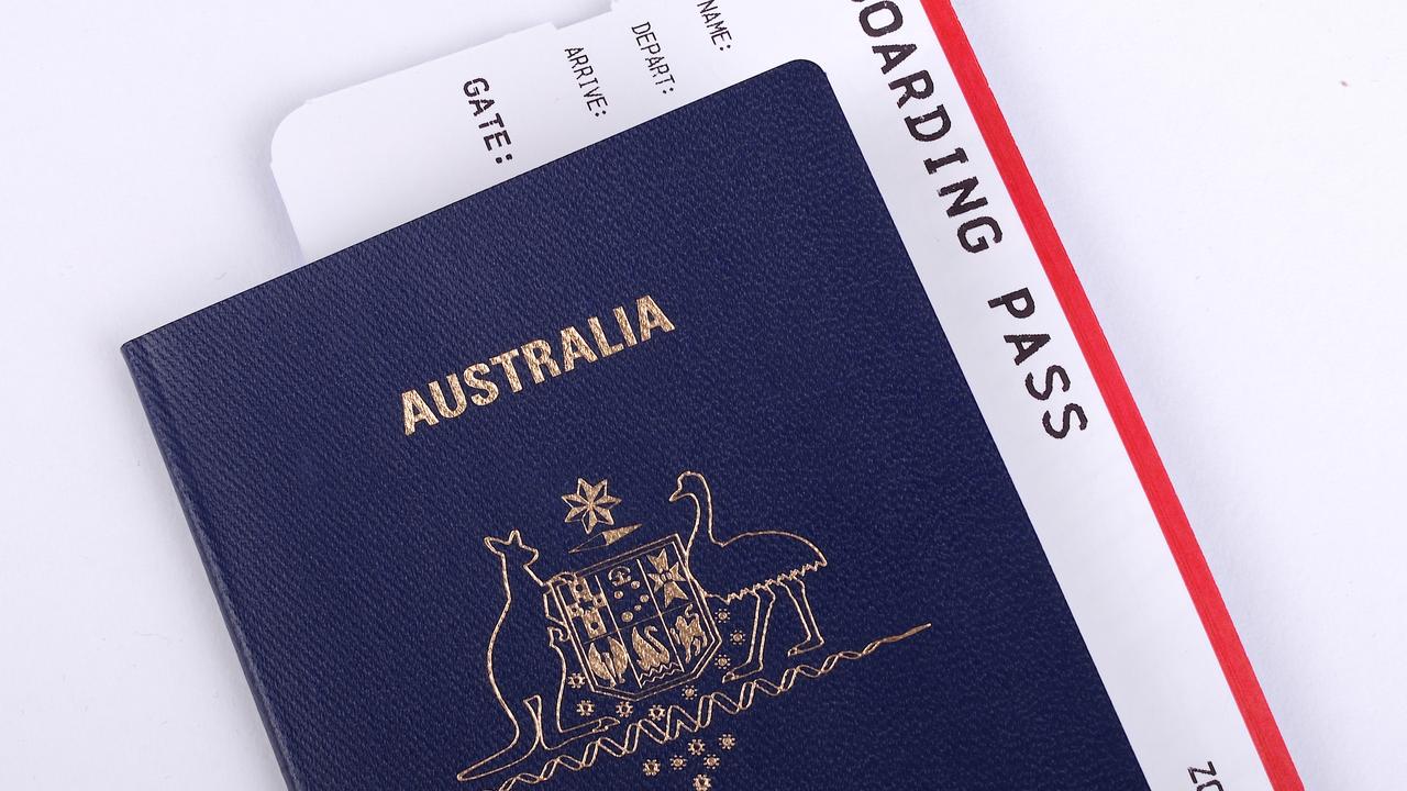 One New Australian passport with an international boarding pass inserted inside the document. Escape 19 November 2023 Doc Holiday Photo – iStock