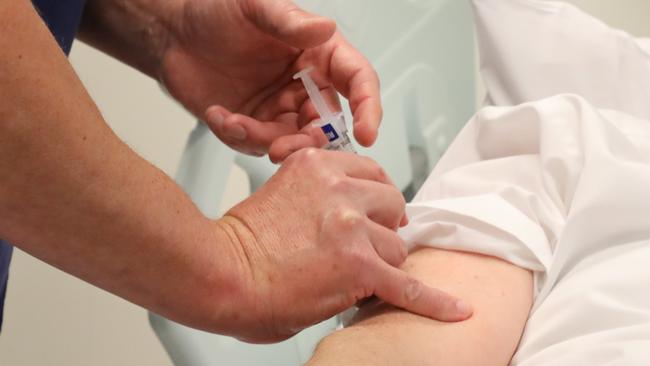 ADELAIDE, AUSTRALIA NewsWire Photos June 30: COVID VACCINE HUMAN TRIALSHuman trials of covid vaccine to start at RAH (Royal Adelaide Hospital). Guy Ludbrook, Professor of Anaesthesia, administers the first vaccine to Pharmacist, Ian Tindall.  NCA NewsWire / Dean Martin