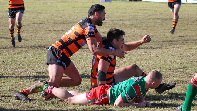 Helensburgh Tigers club legend Steve McCallum celebrates scoring a try. Picture: Dorian Cobb