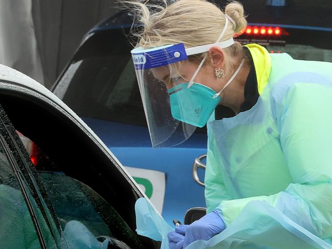 SYDNEY, AUSTRALIA - NewsWire Photos November 1, 2020: Pictured: Pictured at white car is Registered nurseFrancee Drew. She and thew other RNs work in a temporary tent in wet weather at St. VincentÃs Hospital Covid drive through testing clinic at Bond Beach in Sydney, NSW. Picture: NCA NewsWire / Dylan Coker