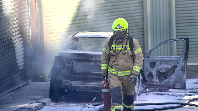 Fire and rescue attend a burnt out car connected to the shooting. Picture: Jeremy Piper