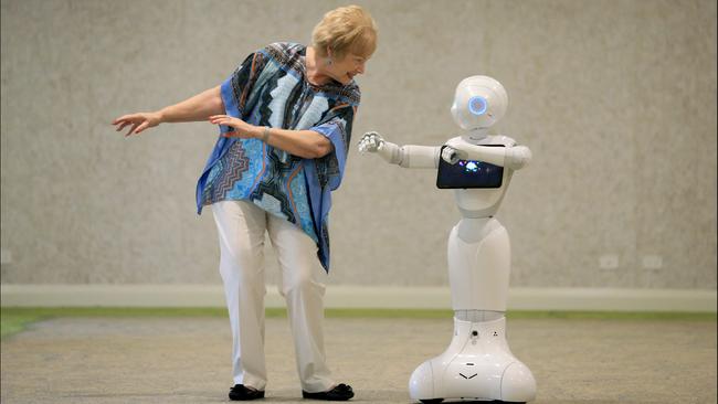 Elements Retirement Living resident Carol Sukkar enjoys a dance session with companion robot Pepper. Picture: Jamie Hanson