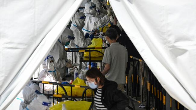 Health workers conduct Covid-19 coronavirus testing at a makeshift testing site in Zhongguancun, in Beijing. Picture: AFP