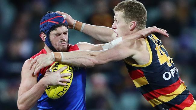 Melbourne's Angus Brayshaw tangles with Crows ruckman Reilly O'Brien Picture: Sarah Reed.