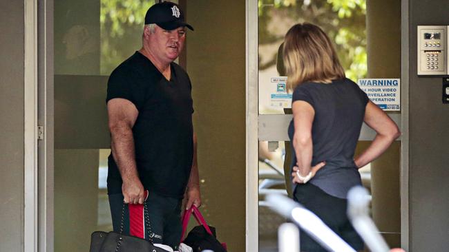 Stuart MacGill chats to a woman outside his Cremorne apartment building on Sunday morning. Picture: Adam Yip