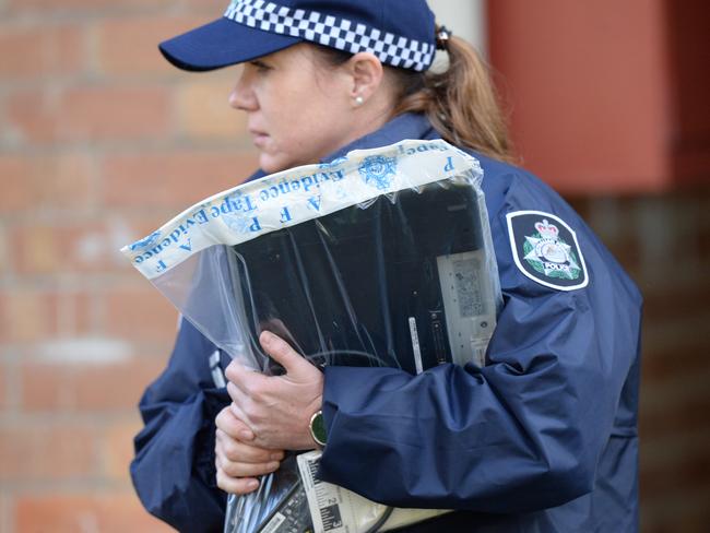 Australian Federal Police remove a laptop in an evidence bag from an address at Ascot Vale, Melbourne, Friday, May 9, 2017. Picture: Mal Fairclough/AAP