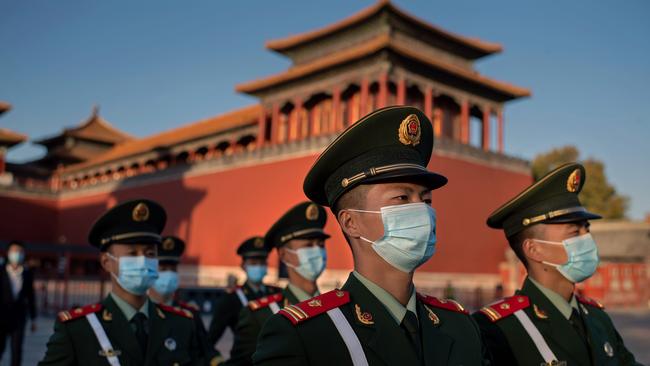 Paramilitary police officers wearing face masks march outside the Forbidden City in Beijing on October 22, 2020, on the eve of the 70th anniversary of China’s entry into the 1950-53 Korean War. Picture: AFP