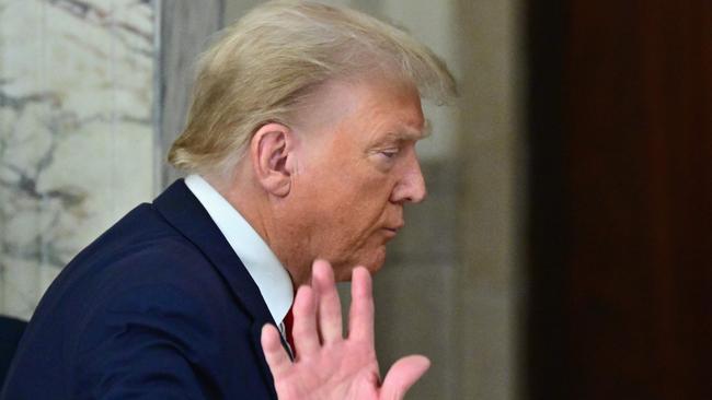 (FILES) Former US President Donald Trump waves after speaking to the media during the third day of his civil fraud trial in New York on October 4, 2023. Former US President Donald Trump on October 6, 2023, denied reports in US media that he had shared US nuclear submarine secrets with an Australian businessman in a meeting at his Florida mansion shortly after leaving office. The New York Times, citing unnamed sources, identified the entrepreneur as billionaire Anthony Pratt, who heads one of the world's largest packaging companies. (Photo by ANGELA WEISS / AFP)