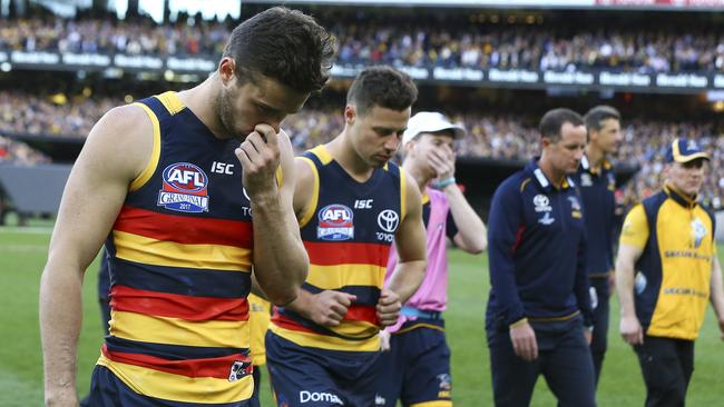 Brad Crouch walks off the MCG after the 2017 Grand Final with teammate Luke Brown, in what would be his last senior game until 2019. Picture: Sarah Reed