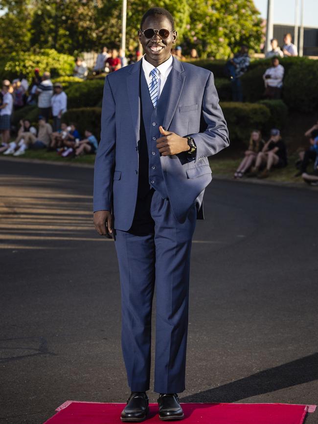 Akol Bol Malek arrives at Harristown State High School formal at Highfields Cultural Centre, Friday, November 18, 2022. Picture: Kevin Farmer