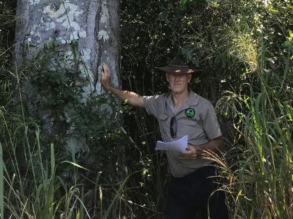 Landcare's Mike Johnson shows the size of the trees.