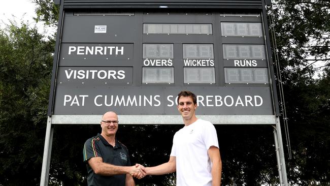 Penrith Club president Paul Goldsmith and Pat Cummins shake hands under the new scoreboard that bears the Australian cricket captain’s name Picture: Getty Images