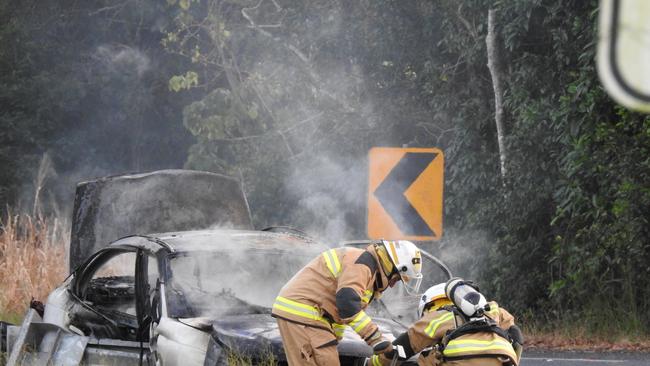 Firefighters work to put out a car blaze on Pine Creek Yarrabah Road. Picture: Supplied