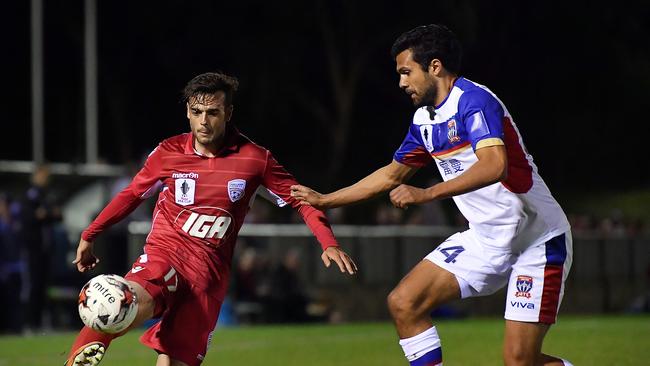 Nikola Mileusnic of United competes for the ball with Nikolai Topor-Stanley of Newcastle