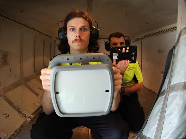 Air Border Security officers check the rear cargo hold walls. Picture: David Caird