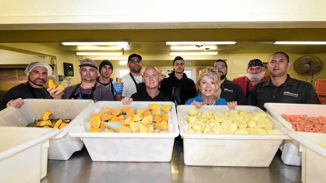 NOMINATED: Bayside Transformations CEO Tina Davie (centre front) with general manager Andy Barton (centre left) with their team of program residents and graduates in the Bayside Vegetable Production kitchen. Picture: Cody Fox