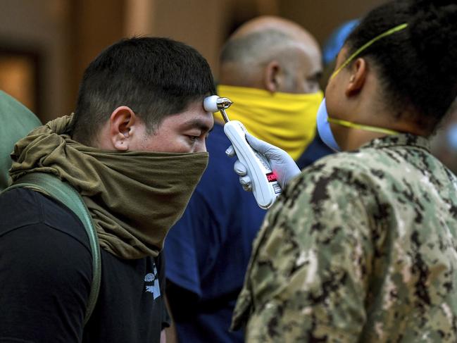 Sailors assigned to the aircraft carrier USS Theodore Roosevelt, who have tested negative for COVID-19 and are asymptomatic, are checked at local hotels in Guam. Picture: Mass Communication Specialist Julio Rivera/U.S. navy via AP