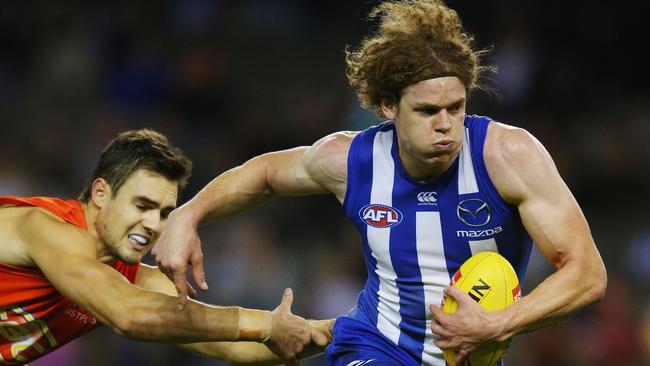 Powerhouse effort ... Ben Brown of the Kangaroos breaks a tackle from Jack Leslie of the Suns. Picture: Michael Dodge (Getty Images)
